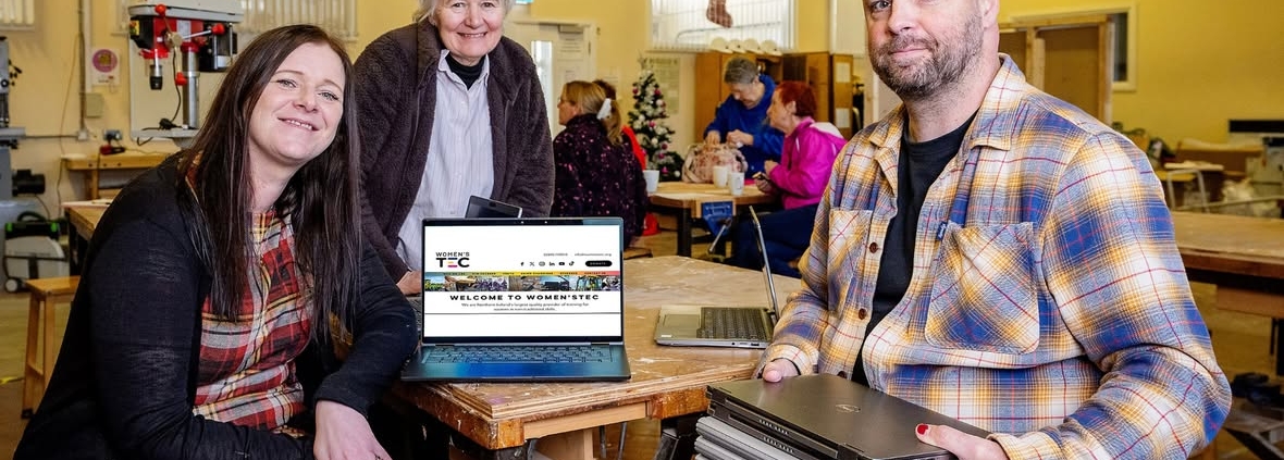 A group of people with a laptop.