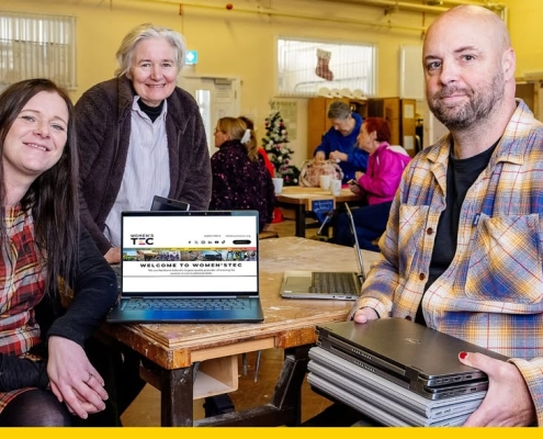 A group of people with a laptop.