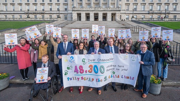 Campaigners from across the Community & Voluntary Sector at Stormont in November 2025 calling for the scrapping of the two-child limit ahead of the Autumn Budget